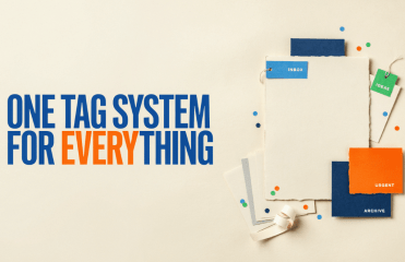 Text reads ONE TAG SYSTEM FOR EVERYTHING next to a collection of paper sheets with colorful project management tags labeled INBOX, IDEAS, URGENT, and ARCHIVE.